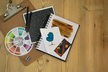 Flat lay of Interior designer work space with sketches, tools and colour chart