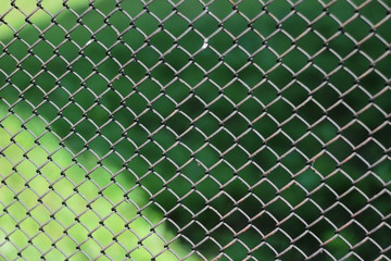 Fence metal mesh. Photo background with a fence. Texture of a metal fence made of mesh closeup.