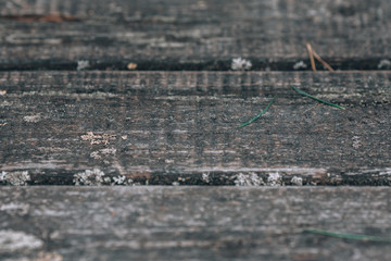 Gray wooden floor vintage. Old lee floor. Street floor made of wood without paint. Photo background with wood texture.