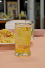 cold glass of beer with ice on wood table.  