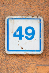 Number 49, forty nine, street number sign on the wall
