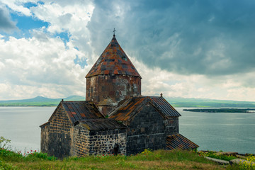 Fototapeta premium Sevan Monastery in Armenia on a cloudy summer day overlooking the lake