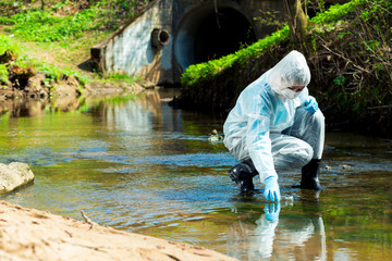 ecological disaster, contaminated water comes out of the sewage system - an ecologist takes a...