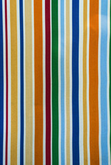 Vertical background of fabric with multi-colored stripes