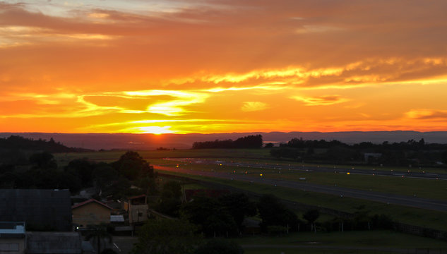 Sunrise over a calm regional airport runway