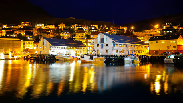 Honningsvag, Norway coastal town with beautiful city light at night captured from offshore.