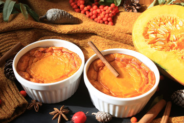 Homemade Pumpkin Souffle. Against an autumn background with a warm sweater, cinnamon sticks, mountain ash.