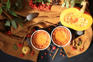 Homemade Pumpkin Souffle. Against an autumn background with a warm sweater, cinnamon sticks, mountain ash.