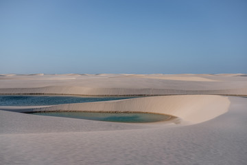 paradise oasis lake in desert with sand dunes Lençois Maranhenses curves
