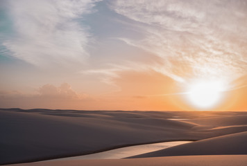 Fototapeta na wymiar paradise oasis lake in desert with sand dunes Lençois Maranhenses sunset