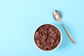 dry breakfast in a plate on a colored background top view. cereal