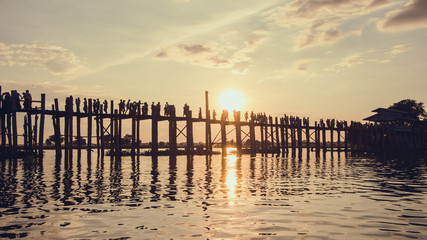 People walking on Bridge U-Bein at sunset scene
