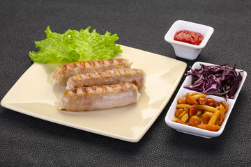 Grilled sausages served mushrooms and cabbage