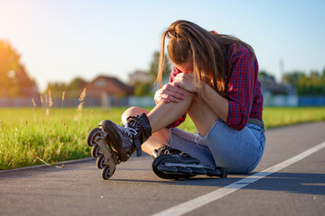 Woman injured knee while rollerblading. A teenager having a bruise after falling while inline...