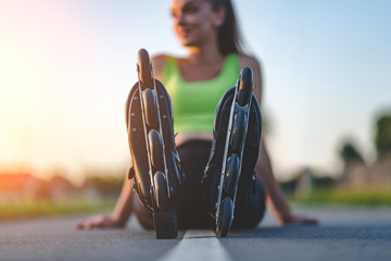 Athletic woman in roller skates during inline skating outdoors. Active lifestyle. Happy teenager...