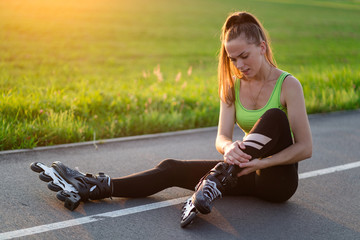 Woman injured knee while rollerblading. A teenager having a bruise after falling while inline...