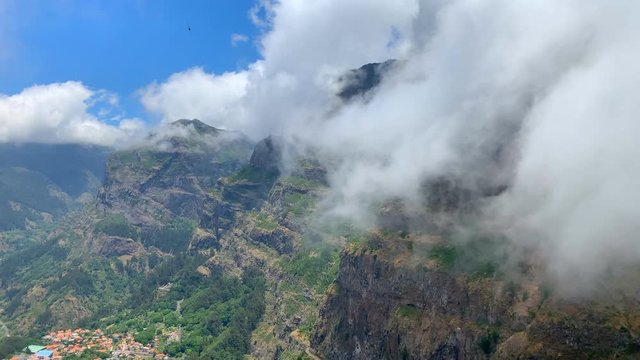 Clouds over the mountains on Madeira island at the Curral das Freiras or Valley of the Nuns.