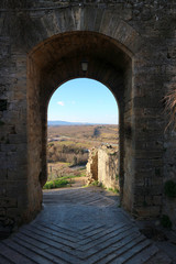 Beautiful view to the tuscany landscape through the gates of medieval town Monteriggioni, Tuscany, Italy