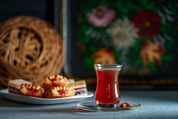 Turkish tea in traditional glass with sweets, dried fruits and nuts for a teatime