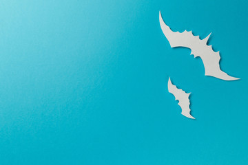 Halloween decorations. Halloween paper decorations on pastel blue background. Top view. Flat lay of accessory decoration Halloween festival. Copy space. Minimal creative concept. Pastel colors