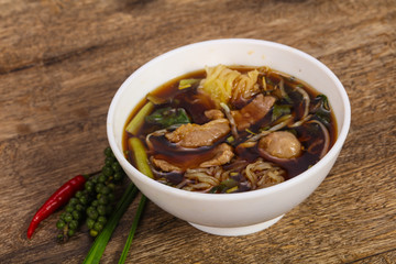 Thai style soup with meat and mushrooms