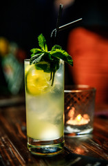 Fresh Mojito cocktail with lime, rosemary, mint and ice in jar glass on. Summer cold drink and cocktail