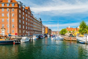 Christianshavn channel with colorful buildings and boats in Copenhagen, Denmark