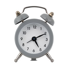 A gray clock with an alarm clock on a white background shows the arrows five hours ten minutes or seventeen hours ten minutes