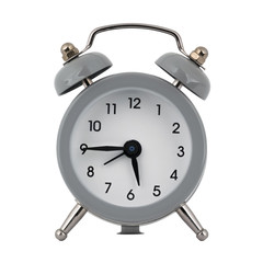 A gray clock with an alarm clock on a white background shows the arrows five hours forty five...