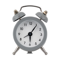 A gray clock with an alarm clock on a white background with arrows showing the time six hours five minutes or eighteen hours five minutes