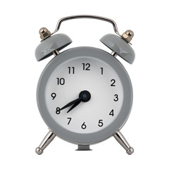 A gray clock with an alarm clock on a white background with arrows showing the time seven hours forty minutes or nineteen hours forty minutes