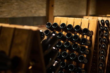 winery with wine bottles and wooden barrel