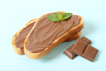 Toast with chocolate paste on the table.