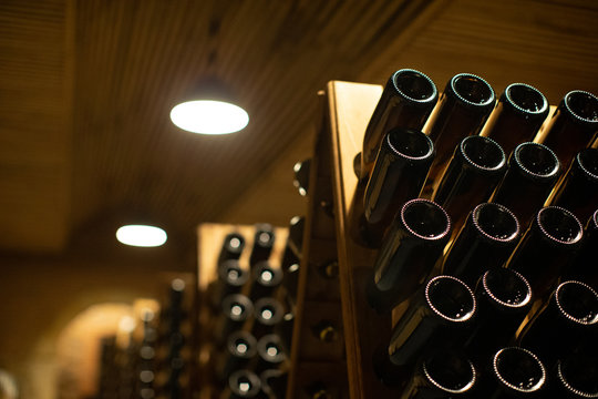 winery with wine bottles and wooden barrel