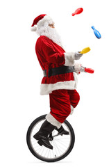 Santa claus riding a unicycle and juggling with clubs © Ljupco Smokovski