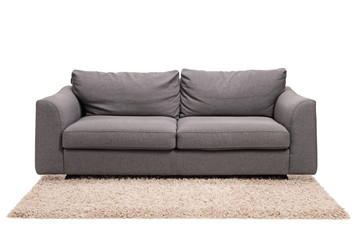 Studio shot of a grey sofa on a carpet