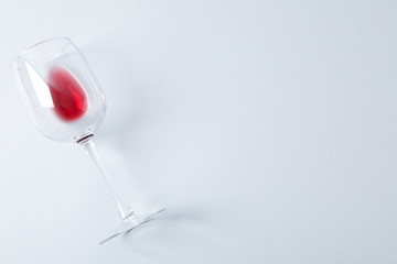 Glass with red wine on grey background, space for text