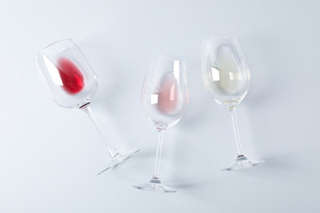 Flat lay. Glasses with different wine on grey background, copy space
