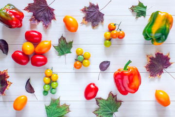 Peppers, tomatoes on a white table. Top view and health on white background. Autumn theme.