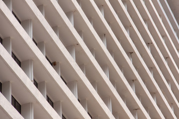 Glass windows and concrete walls in the daytime. Arcitectural fragment of modern building in Bangkok, Thailand.