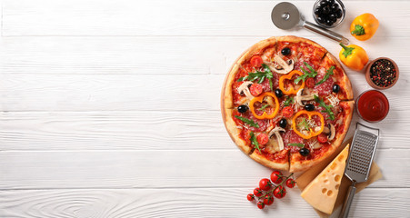 Delicious pizza and ingredients on white wooden background, copy space