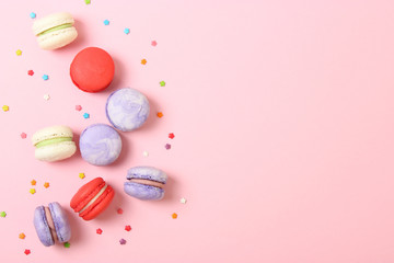 macaroons on a colored background top view.