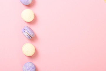 macaroons on a colored background top view.