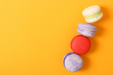 macaroons on a colored background top view.