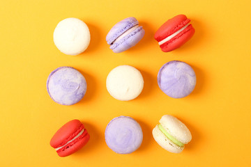 macaroons on a colored background top view.
