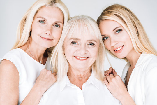 portrait of three generation blonde women isolated on grey