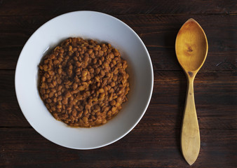 plate of lentils with wooden spoon