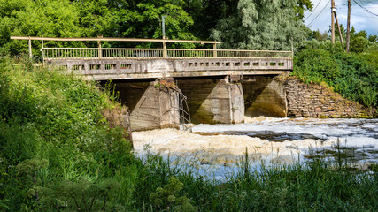 Fototapeta na wymiar Old bridge on the river Izhora