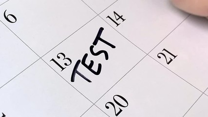 Test written in black marker on a calendar agenda page