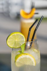 Mojito cocktail with lime and mint in a glass. Freshness cocktail, closeup
